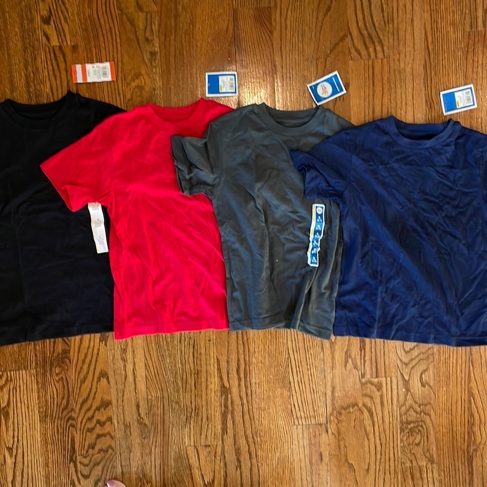 Set of four t-shirts NWT: red, dark grey, navy, black small (6/7) and XS (4/5).
